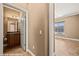 View of a half bath with a wood vanity and a view to an adjacent room with a window at 1455 Waterfall Ln, Mesquite, NV 89034