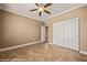 Bedroom featuring tile flooring, ceiling fan, closet, and neutral colored walls at 1455 Waterfall Ln, Mesquite, NV 89034