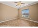 Empty room showcasing tile flooring, ceiling fan, and a window bringing in natural light at 1455 Waterfall Ln, Mesquite, NV 89034