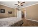 Spacious bedroom with crown molding, neutral walls, and bathroom access at 1455 Waterfall Ln, Mesquite, NV 89034