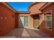 Spacious courtyard with stone pavers, an exterior door and sliding glass door at 1455 Waterfall Ln, Mesquite, NV 89034