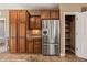 Kitchen with stainless steel refrigerator and ample wood cabinet storage space at 1455 Waterfall Ln, Mesquite, NV 89034