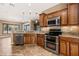 Beautiful kitchen featuring stainless steel appliances, tile floors, and wood cabinets at 1455 Waterfall Ln, Mesquite, NV 89034