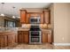 Kitchen with double oven, microwave, wood cabinetry, and granite countertops at 1455 Waterfall Ln, Mesquite, NV 89034