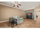 Relaxing living room featuring tile flooring, a ceiling fan, and modern media center at 1455 Waterfall Ln, Mesquite, NV 89034