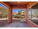 A screened-in patio featuring brick flooring and a view of the outdoor pergola at 1455 Waterfall Ln, Mesquite, NV 89034