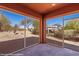 Enclosed patio with brick floor, offering a serene view of the landscaped backyard with a gazebo at 1455 Waterfall Ln, Mesquite, NV 89034