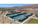 Several pickleball courts featuring blue surfacing and black fencing with desert surroundings at 1455 Waterfall Ln, Mesquite, NV 89034