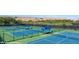 Outdoor tennis courts featuring well-maintained green and blue courts and shaded seating areas at 1455 Waterfall Ln, Mesquite, NV 89034