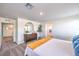 Bedroom featuring neutral walls, a round mirror above a dresser, and carpeted floors at 189 Biscotti Ave # Lot 17, North Las Vegas, NV 89084