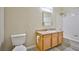 Well-lit bathroom with vanity, mirror, toilet, and shower-tub combination with tiled walls at 2131 Hussium Hills St # 104, Las Vegas, NV 89108