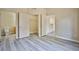 Bedroom featuring gray wood-look flooring, neutral walls, closet, and an attached bathroom at 2131 Hussium Hills St # 104, Las Vegas, NV 89108