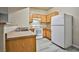 Bright kitchen features white appliances and wood cabinets at 2131 Hussium Hills St # 104, Las Vegas, NV 89108