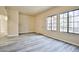 Bright living room with gray wood-look flooring and large grid windows that let in plenty of natural light at 2131 Hussium Hills St # 104, Las Vegas, NV 89108