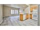 Bright open-plan living room and kitchen with wood-look floors at 2131 Hussium Hills St # 104, Las Vegas, NV 89108