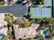 An aerial view of a house with a pool, tennis court, and lush greenery at 2285 Villefort Ct, Las Vegas, NV 89117