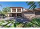 Expansive backyard featuring a covered patio, outdoor kitchen, and lush landscaping perfect for outdoor living at 2285 Villefort Ct, Las Vegas, NV 89117