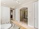 Well-appointed bathroom featuring a soaking tub, a glass-enclosed shower, and neutral tones at 2285 Villefort Ct, Las Vegas, NV 89117