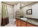 Bright bathroom features a granite-topped vanity and shower-tub combination with curtains at 2285 Villefort Ct, Las Vegas, NV 89117