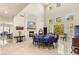 Bright dining room featuring a stone fireplace, high ceilings, and clerestory windows at 2285 Villefort Ct, Las Vegas, NV 89117