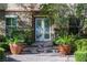 Close up of elegant double front doors flanked by lush landscaping and stone accents at 2285 Villefort Ct, Las Vegas, NV 89117