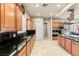 Well-equipped kitchen with granite countertops, stainless steel appliances and center island cooktop at 2285 Villefort Ct, Las Vegas, NV 89117