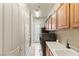 Functional laundry room with ample cabinet space, a utility sink, and modern washer/dryer units at 2285 Villefort Ct, Las Vegas, NV 89117