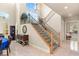 Elegant staircase with carpeted steps, iron railings, and a chandelier at 2285 Villefort Ct, Las Vegas, NV 89117