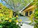 Charming backyard patio featuring mature landscaping, vibrant flowers, and easy access to the house at 2357 Wisconsin Dells Dr, Henderson, NV 89044