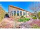 Well-maintained backyard with artificial grass, mature landscaping, and natural stone accents at 2357 Wisconsin Dells Dr, Henderson, NV 89044