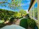 Lush backyard landscaping with artificial grass accents and stone pathway at 2357 Wisconsin Dells Dr, Henderson, NV 89044