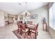 Elegant dining area with a decorative chandelier and tiled floors flows into other living spaces at 2357 Wisconsin Dells Dr, Henderson, NV 89044