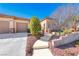 Charming home featuring desert landscaping and a three-car garage at 2357 Wisconsin Dells Dr, Henderson, NV 89044