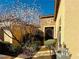 Inviting entrance with iron gate, manicured bushes, and stone accents, offering curb appeal at 2357 Wisconsin Dells Dr, Henderson, NV 89044