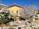 Cozy home with wintery landscaping, including snow-dusted trees and bushes at 2357 Wisconsin Dells Dr, Henderson, NV 89044