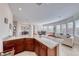 Modern kitchen featuring stone countertops, bar seating and an open layout to the living area at 2357 Wisconsin Dells Dr, Henderson, NV 89044
