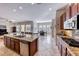 Spacious kitchen featuring a granite island, stainless steel appliances, and an open layout to the dining area at 2357 Wisconsin Dells Dr, Henderson, NV 89044
