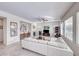 Open-concept living room with white sofa, fireplace, and tile flooring, creating a bright and inviting space at 2357 Wisconsin Dells Dr, Henderson, NV 89044