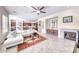 Bright living room with a fireplace, a white sofa, tile flooring, and seamlessly connected to the kitchen area at 2357 Wisconsin Dells Dr, Henderson, NV 89044