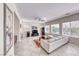 Open-concept living room with a white sofa, tile flooring, fireplace, and lots of natural light from the windows at 2357 Wisconsin Dells Dr, Henderson, NV 89044