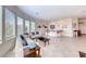 Comfortable living room with large windows and bar seating offers seamless entertaining at 2357 Wisconsin Dells Dr, Henderson, NV 89044