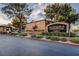 Community sign with mature landscaping, tree-lined streets and guarded entrance at 2451 N Rainbow Blvd # 1150, Las Vegas, NV 89108