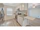 Kitchen with stainless steel refrigerator and stove, granite countertops, and wood-look vinyl flooring, adding modern appeal at 2451 N Rainbow Blvd # 1150, Las Vegas, NV 89108