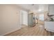 Charming kitchen with stainless steel refrigerator and white cabinets, complemented by wood-look vinyl floors at 2451 N Rainbow Blvd # 1150, Las Vegas, NV 89108