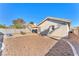 Spacious backyard with gravel landscaping, a covered patio, and block wall, great for outdoor activities at 2459 Avenida Cataluna, Henderson, NV 89074