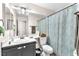 Bathroom featuring a white sink and vanity, toilet, mirror, and a shower with a blue patterned curtain at 2459 Avenida Cataluna, Henderson, NV 89074