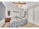 Bright bedroom featuring ceiling fan, neutral walls, plush carpet, and access to natural light through the window at 2459 Avenida Cataluna, Henderson, NV 89074