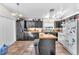 Kitchen featuring dark cabinets, a butcher block island, tile floors, and lots of natural light at 2459 Avenida Cataluna, Henderson, NV 89074