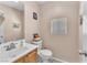 Well-lit bathroom features a vanity with a sink, toilet, and small window at 2526 Begonia Valley Ave, Henderson, NV 89074