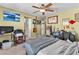 Bedroom with light walls, ceiling fan, and artwork at 2526 Begonia Valley Ave, Henderson, NV 89074